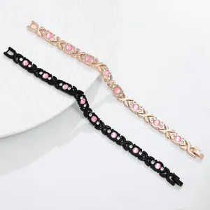 Detail view of elegant magnetic bracelets in gold and black with pink rhinestones