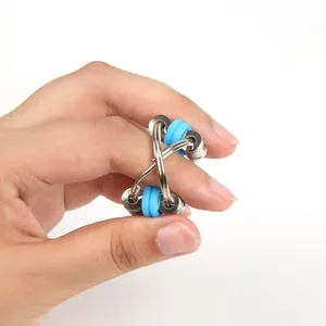 Detail of blue silicone and metal bicycle chain fidget toy held in hand for stress relief