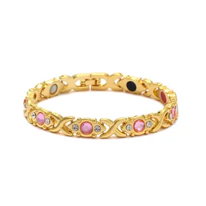 Detailed macro view of elegant gold-plated energy magnet bracelet with pink stones