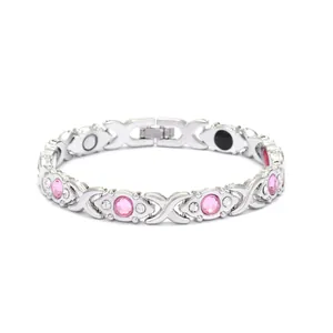 Detailed view of women's silver magnetic bracelet featuring pink crystals and rhinestones