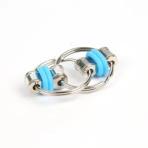 Close-up of a metal bike chain fidget toy keychain with blue silicone rings on white
