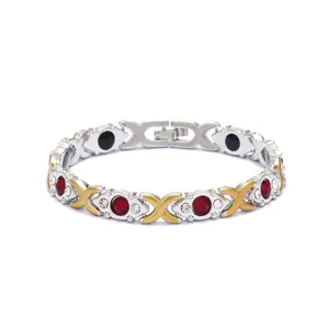 Fashion magnetic therapy bracelet with red crystals and golden X links on silver band