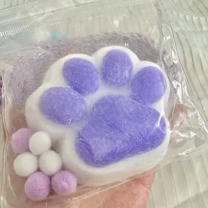Close-up of giant cat paw squishy toy in purple and white colors for stress relief