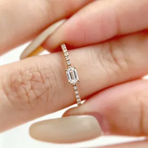 Elegant rose gold band ring featuring a sparkling emerald-cut simulated diamond stone.