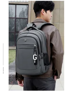 Grey large capacity Oxford cloth backpack worn by male model in outdoor city setting