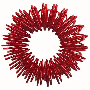 Detailed close-up view of a bright red metallic spring finger massage ring for stress relief
