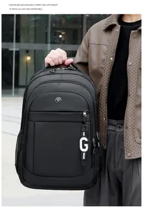 Close-up of a large black Oxford cloth backpack for travel and school with logo details.