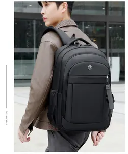 Detailed back view of a large black Oxford cloth travel backpack shown on a male model