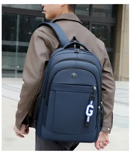 Men's large capacity navy blue Oxford cloth backpack shown in an outdoor lifestyle setting
