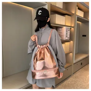 Detail view of rose gold metallic gym drawstring backpack with separate shoe compartment