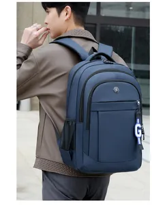 Men's large capacity blue Oxford cloth backpack worn by a model in an urban street