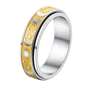 Stainless steel spinner ring with celestial sun moon and star motifs in silver and gold