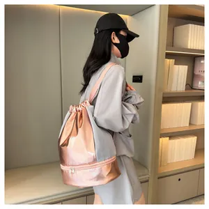 Model wearing a rose gold metallic gym backpack with a separate shoe compartment