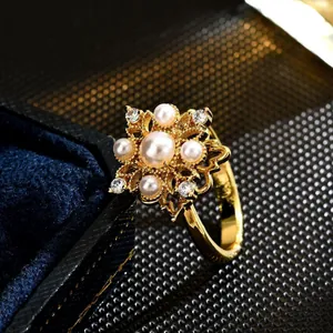 Elegant gold-tone rotatable flower ring decorated with faux pearls and crystals for women