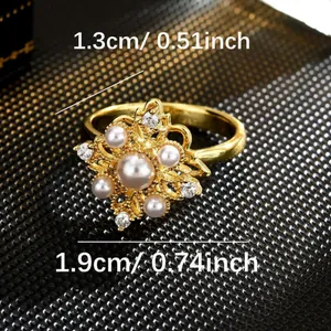Rotating gold fidget ring featuring an elegant floral design with faux pearls and gems