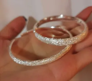 Detailed view of the frosted starry sky texture on silver-plated open-ended bangles