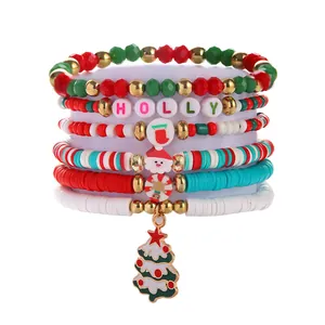 Close-up of festive Christmas beaded bracelet stack with Santa and Holly letter charms