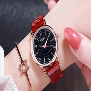 Detail view of a starry sky dial watch with red magnetic mesh strap and bracelet.