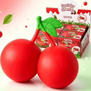 Detailed view of giant red cherry squishy toy with vibrant green leaves and packaging.