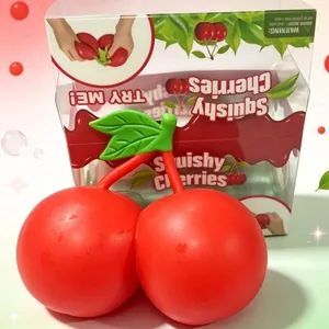 Macro detail of giant red squishy cherry toy with transparent gift box packaging