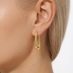 Elegant S925 sterling silver gold plated U-shaped hoop earrings worn by a female model