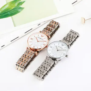 Detail view of two minimalist couple quartz watches with silver and rose gold metal bands