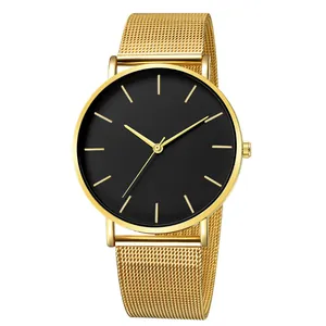 Detailed view of a minimalist gold mesh strap watch with a classic matte black dial