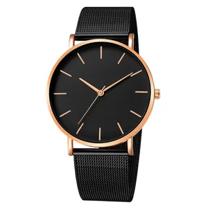 Close-up detail of a minimalist quartz watch with black mesh strap and rose gold finish