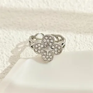 Detailed macro view of a four-leaf clover stainless steel ring with micro-paved zirconia