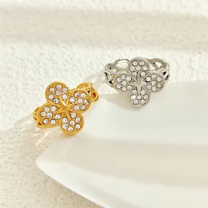 Detail view of gold and silver clover rings with micro-pave zirconia stones
