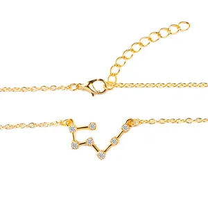 Close-up of gold constellation necklace with sparkling zircon stones and lobster clasp.