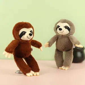 Close-up detail of brown and grey cute sloth plush toy keychains hanging ornaments