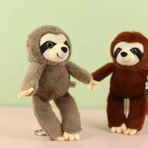 Close-up detail of two cute sloth plush keychains in grey and brown colors for bags