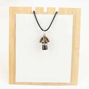 Detailed view of handmade tiger eye mushroom pendant with vintage silver wire wrapping