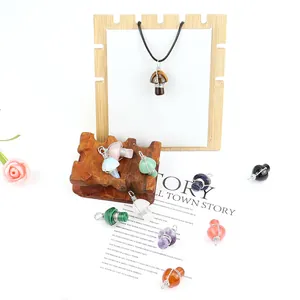 Detailed view of assorted handmade wire-wrapped natural crystal mushroom pendants.