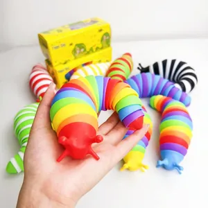 Handheld macro detail of rainbow articulated fidget slug toy with vibrant color segments