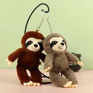 Detail view of two cute plush sloth keychains in brown and grey hanging from a stand.