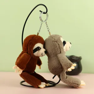 Detailed side view of cute brown and grey sloth plush toy keychains on a stand