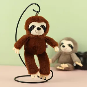 Close-up view of a brown plush sloth keychain hanging on a black metal display stand.