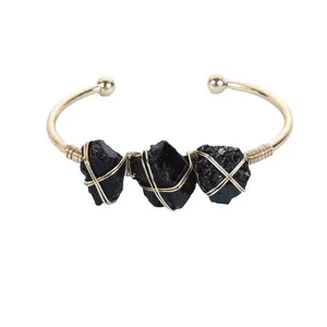 Fashionable gold open cuff bracelet featuring three raw black natural stones jewelry