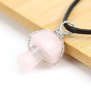 Close-up of vintage handmade wire-wrapped pink rose quartz crystal mushroom pendant necklace.