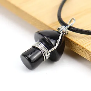 Macro view of a handmade wire-wrapped black stone mushroom pendant jewelry piece