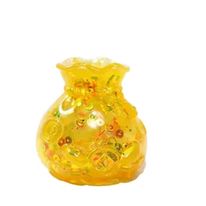 Juguete squishy de maltosa amarillo translúcido en forma de bolsa de la suerte con lentejuelas