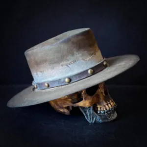 Detailed macro view of distressed wool fedora with leather band and metal studs