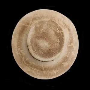 Top view of a vintage distressed wool top hat with brown textured accents