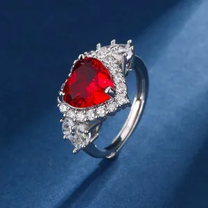Detailed macro view of heart-shaped red garnet ring with sparkling crystal halo