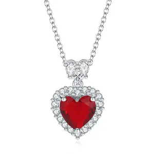 Detailed close-up of a silver heart pendant necklace with a vibrant red garnet stone