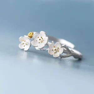 Detailed macro view of retro silver plum blossom ring with exquisite gold stamens