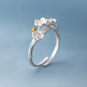 Elegant silver plum blossom ring with golden stamens and adjustable branch band