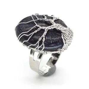 Detail showing the intricate silver wire-wrapped tree of life design on an oval blue stone.